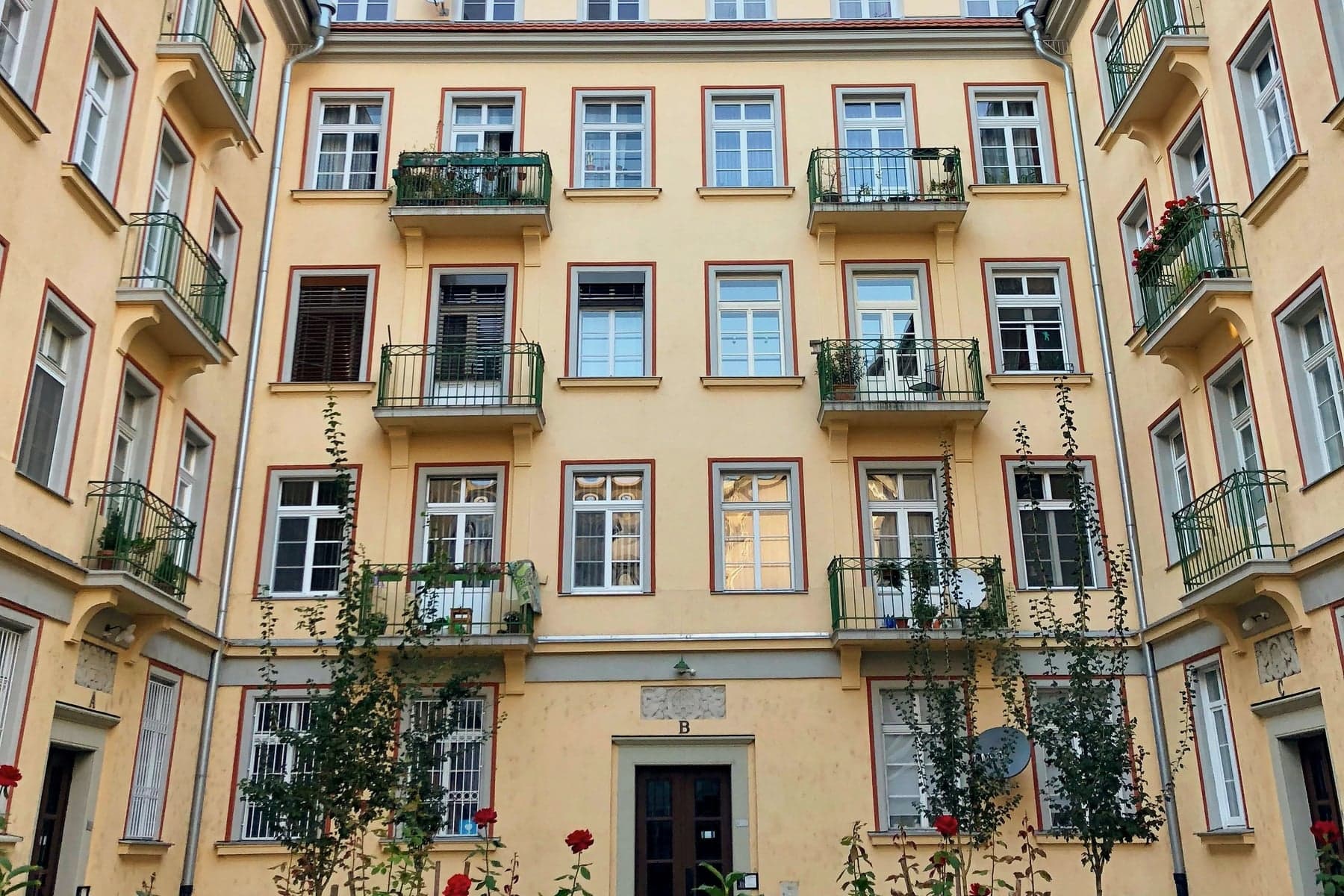 Innergård med bostadsfönster och balkonger mot lugnare sida